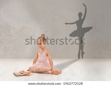 Little girl looking at pointe shoes, dreaming to become famous ballerina, shadow of ballet dancer on grey studio wall, collage. Adorable child imagining her dance success, making dream come true Royalty-Free Stock Photo #1962772528