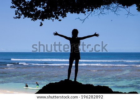 silhouette of the teen girl standing on the beach at  the day time