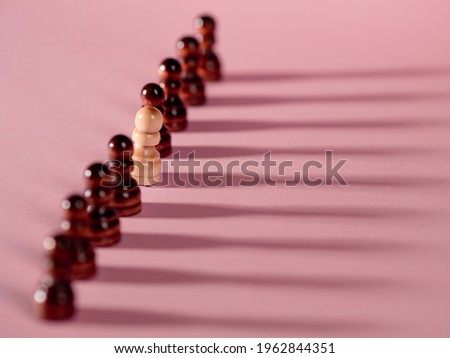 chess pieces in a row, pawns on a pink background, team concept