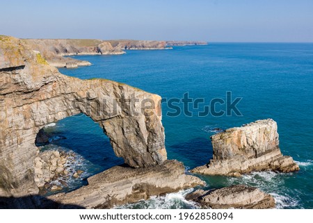 Beautiful natural archway and rugged ocean coastline (Green Bridge of Wales, Castlemartin, Pembroke) Royalty-Free Stock Photo #1962858094