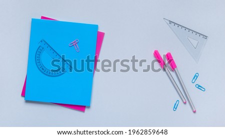 Flat lay of back to school supplies with  notebook and pen.