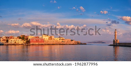 Panorama of picturesque old port of Chania is one of landmarks and tourist destinations of Crete island in the morning on sunrise. Chania, Crete, Greece Royalty-Free Stock Photo #1962877996
