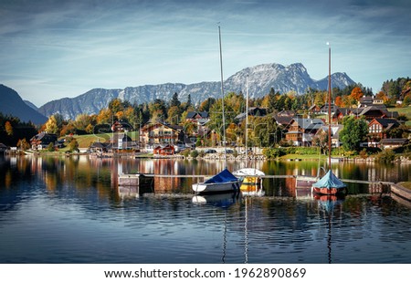 Wonderful Autumn Landscape in Austrian Alps with perfect sky. Awesome Fairy tale lake at Alpine Highlands in Autumn in Sunny day . Amazing Nature Scenery. Grundlsee, Styria, Austria. Popular resort