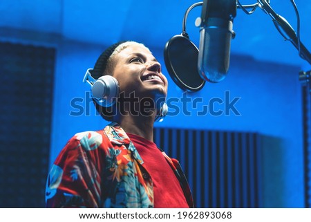 Young professional female singer recording a new song album inside music production studio   Royalty-Free Stock Photo #1962893068