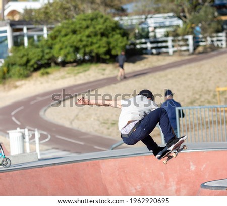 young man skateboarding in skatepark