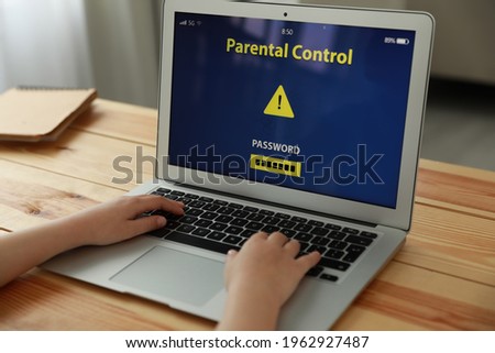 Child using laptop with installed parental control app at home, closeup. Cyber safety