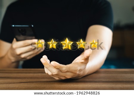 Rating and feedback Positive customer review experience, satisfaction survey, customer experience concept, five-star rating floating in the hand.