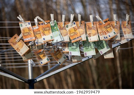 100 and 50 euro banknotes drying. Washed Euro paper bills. Drying euro on a string.Money laundering Royalty-Free Stock Photo #1962959479