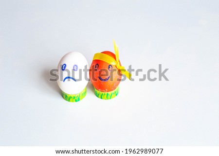 Cute emoticons drawn on easter eggs decorated with ribbon on white background