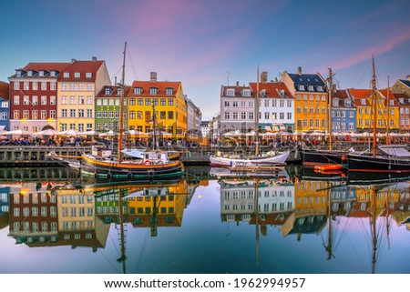 Cityscape of downtown Copenhagen city skyline in Denmark at famous old Nyhavn port at sunset Royalty-Free Stock Photo #1962994957