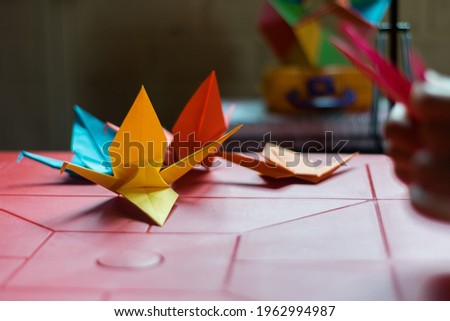 colorful cranes on a red plastic table