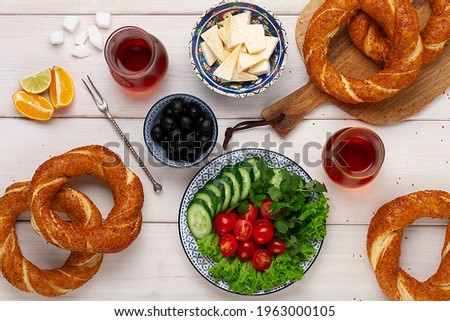 Traditional Turkish bagel simit, breakfast, on a wooden table, rustic, horizontal, no people,
