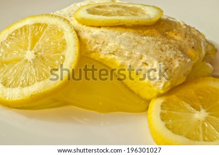 lemon square dessert with cheese topping and lemon slices
