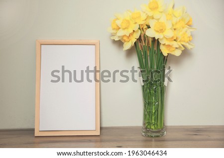 yellow flowers and photo frame on the table