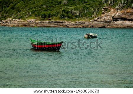 Canoes on water with landscape on background