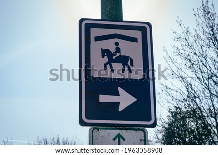 Sign with the symbol of a manage or horse riding school