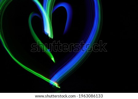 Colorful luminous hearts. Light painting. Long exposure photography.
