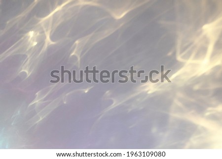 Blurred water texture overlay effect for photo and mockups. Organic drop diagonal shadow and light caustic effect on a white wall. Shadows for natural light effects Royalty-Free Stock Photo #1963109080