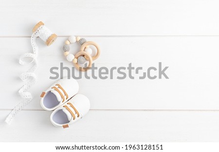 Gender neutral baby shoes and accessories. Organic newborn fashion, branding, small business idea Royalty-Free Stock Photo #1963128151