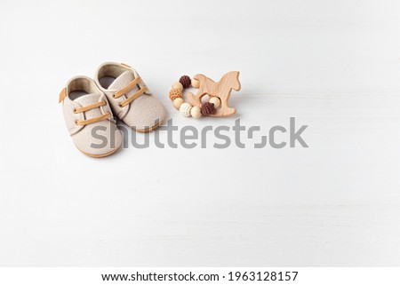 Gender neutral baby shoes and accessories. Organic cnewborn fashion, branding, small business idea Royalty-Free Stock Photo #1963128157