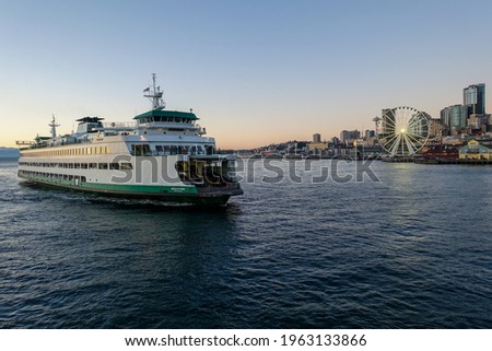 A Washington State Ferry approaches downtown Seattle after sailing across the Puget Sound in the middle of a Pacific Northwest summer