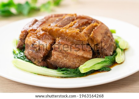 Braised pork belly with yam served with green vegetable Royalty-Free Stock Photo #1963164268