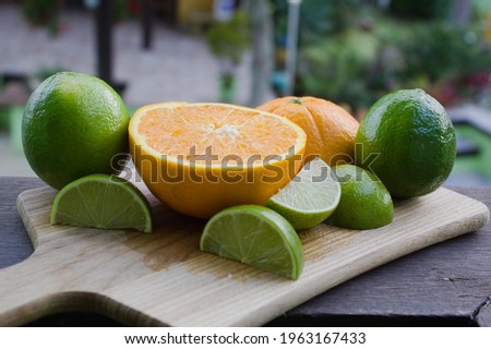 Lemon and orange on a wooden cutting board