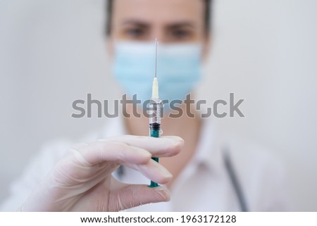 Female Doctor preparing the coronavirus COVID-19 vaccine