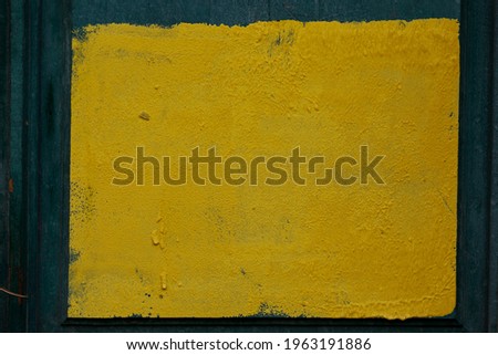 square of yellow paint on the wall.