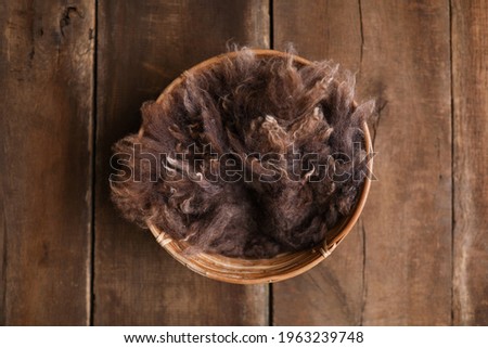 Newborn photography digital background prop. Wood basket with brown fur and on a wooden background