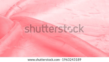 Silk fabric Red White. Dented and smoothed with traces of stripes. Texture background. Matte wedding satin fabric. These sophisticated lightweight stretch satin textiles create a stylish look.