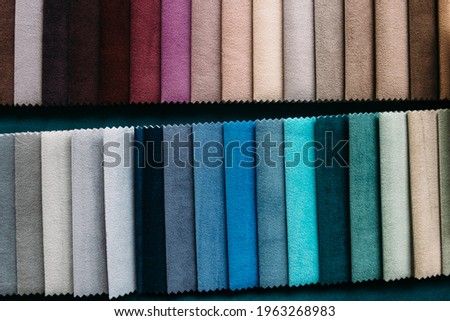 Collection of colorful velour textile samples. Fabric designed for sofas and armchairs. Fabric texture background