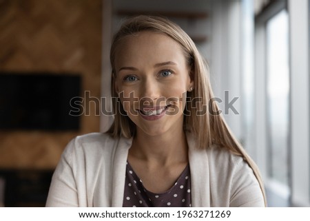 Profile picture of smiling Caucasian woman look at camera talk speak on video call online. Headshot portrait of happy young female have webcam digital virtual zoom conference. Communication concept.