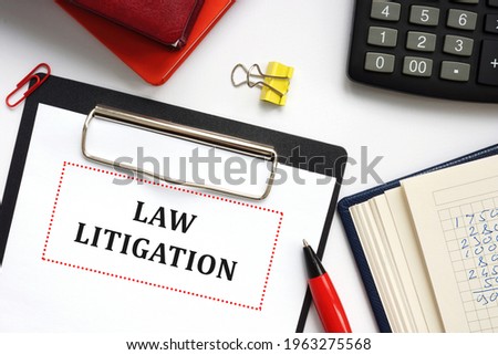 Business concept meaning LAW LITIGATION with sign on the page. 
