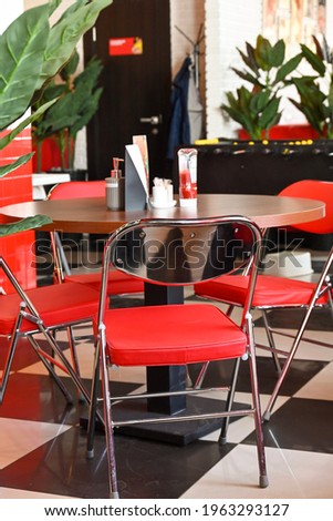 red chair at a table in a cafe