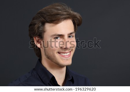 Handsome man with perfect white smile on dark gray background