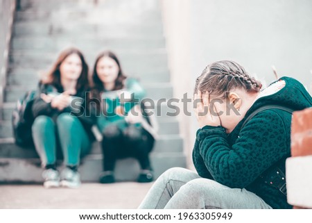 Girl being bullied at the school. Educational school isolation and bullying concept.