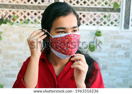 double mask prevent infection, Young indian girl wearing two face mask to protect from new strain of coronavirus or new wave of covid-19 outbreak in india. omicron cases. 