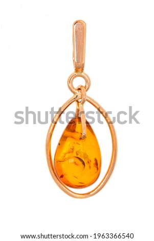 Gold pendant with amber close-up. Jewelry, accessory isolated on white background. Royalty-Free Stock Photo #1963366540