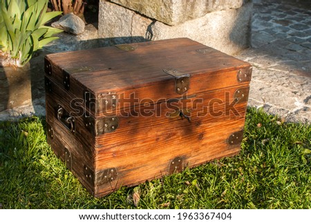 Old retro vintage wooden chest on house garden closeup