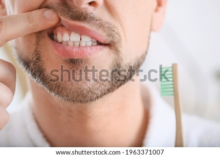 Man suffering from tooth ache in morning, closeup Royalty-Free Stock Photo #1963371007