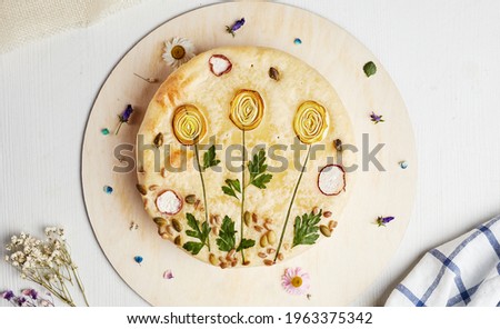 cake with a picture of flowers on a wooden base on a light background top view 