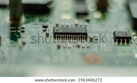 Complex electronics, green circuit board with a microcontroller Royalty-Free Stock Photo #1963406272