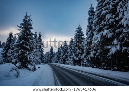 Winter road in the mountains during snow storm