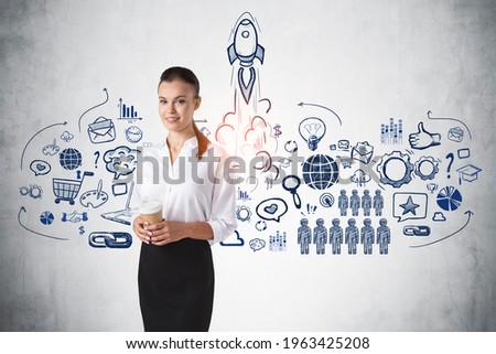 Attractive businesswoman holding coffee cup and dreaming about launching a new fintech start up. Business icons sketch on concrete wall. Concept of success and new business project