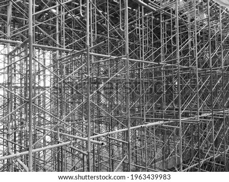 Steel scaffolding installed within the building construction site. It's a black and white picture