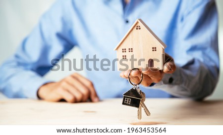 House model with real estate agent and customer discussing for contract to buy house, insurance or loan real estate,real estate concept.