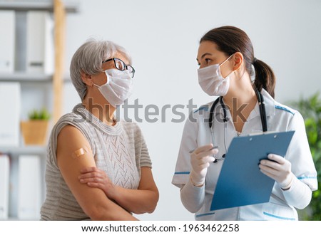 Senior woman after vaccination and her doctor. Virus protection. COVID-2019.