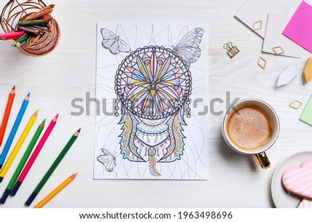 Antistress coloring page, pencils and coffee on white wooden table, flat lay