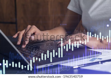 Woman hands typing the keyboard to research stock market to proceed right investment solutions. Internet trading and wealth management concept. Casual wear. Hologram Forex chart over close up shot